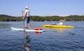 Man on Paddleboard Woman on Kayak Royalty Free Stock Photo