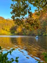 Man Paddleboarding in Autumn Lake Royalty Free Stock Photo