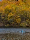 Man Paddleboarding in Autumn Lake Royalty Free Stock Photo