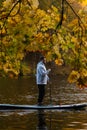 Man Paddleboarding in Autumn Lake Royalty Free Stock Photo