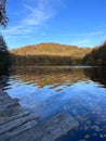 Man Paddleboarding in Autumn Lake Royalty Free Stock Photo