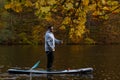 Man Paddleboarding in Autumn Lake Royalty Free Stock Photo