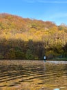 Man Paddleboarding in Autumn Lake Royalty Free Stock Photo