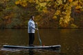 Man Paddleboarding in Autumn Lake Royalty Free Stock Photo