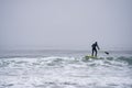 Man paddleboaring in a drysuit wetsuit cold waters York Maine Royalty Free Stock Photo