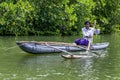 A man paddles an outrigger canoe in Sri Lanka. Royalty Free Stock Photo