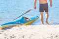 Man paddling a blue and yellow kayak on the river near the shore. Kayaking concept.A man swims in a canoe on the river. Royalty Free Stock Photo