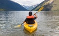 Man paddling kayak in mountain lake Royalty Free Stock Photo