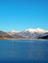 Man paddling on a lake in the French Alps