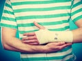 Man with painful bandaged hand. Royalty Free Stock Photo