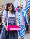 A man in with painted face and blue and white squares and a drag queen attending the Gay Pride in Munich