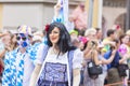 A man in with painted face and blue and white squares and a drag queen attending the Gay Pride in Munich
