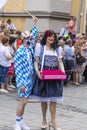 A man in with painted face and blue and white squares and a drag queen attending the Gay Pride in Munich