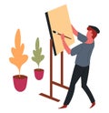 Man painter and easel with paintbrush painting hobby and art