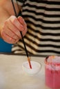 Man painter is mixing colors before painting at art paint studio. Artist in his hand holding paintbrush mixed color oil paints.