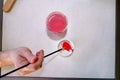 Man painter is mixing colors before painting at art paint studio. Artist in his hand holding paintbrush mixed color oil paints. Royalty Free Stock Photo