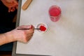 Man painter is mixing colors before painting at art paint studio. Artist in his hand holding paintbrush mixed color oil paints. Royalty Free Stock Photo