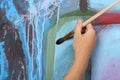 Man painting blue abstract picture