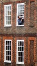 Man painting his window frame