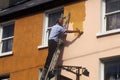 Man painting a house in Cork, Ireland