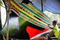 Man painting Malayu style art on boat.is call