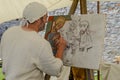 Man painting at the medieval market on Castelgrande castle at Be