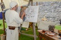 Man painting at the medieval market on Castelgrande castle at Be