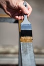 Man is painting a metal railing with copper varnish Royalty Free Stock Photo