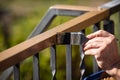 Man is painting a metal railing with copper varnish Royalty Free Stock Photo