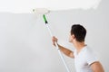 Man Painting Wall With Paint Roller Royalty Free Stock Photo