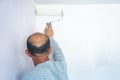 Man painting wall with roller in home interior renovation project, back view Royalty Free Stock Photo