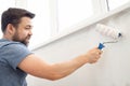 Man painting wall roller with white paint Royalty Free Stock Photo