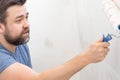 Man painting wall roller with white paint Royalty Free Stock Photo