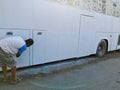 Man Painting white bus