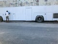 Man Painting white bus