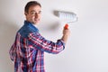 Smiling man painting a wall of his house in white Royalty Free Stock Photo