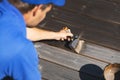 Man painting wooden terrace planks with wood protection oil Royalty Free Stock Photo