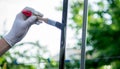 a man paints metal with black paint with a brush Royalty Free Stock Photo