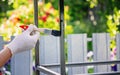 a man paints metal with black paint with a brush Royalty Free Stock Photo