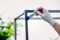 a man paints metal with black paint with a brush Royalty Free Stock Photo