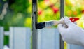 a man paints metal with black paint with a brush Royalty Free Stock Photo