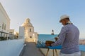 Man paints sea and Church Royalty Free Stock Photo