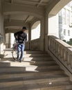 Man in palace of justice corridor carries bicycle in city of luxemburg
