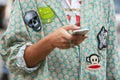 Man with pale green jacket and fabric stickers before Fay fashion show, Milan Fashion Week street style on