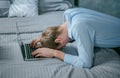 The man, in a panic, put his head on the keyboard of his laptop. Working as a Freelancer at Home in Times of Crisis