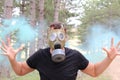 Man panicking in the forest with gas mask