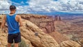 Man With Panoramic View On Buck Canyon Seen From Mesa Arch Near Moab, Canyonlands National Park, San Juan County, Utah, USA
