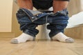 Man with pants down sitting at the toilet Royalty Free Stock Photo
