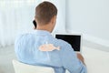 Man with paper fish on his back working with laptop Royalty Free Stock Photo