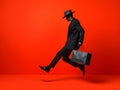 Man with paper shopping bag on red background, movement, emotions, black Friday